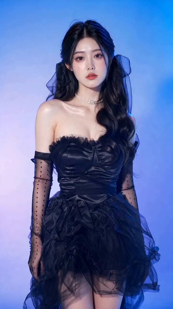 A young East Asian woman in an elegant black gothic coquette dress with